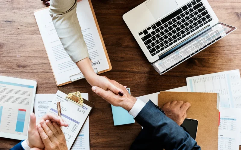 business-people-shaking-hands-together 1