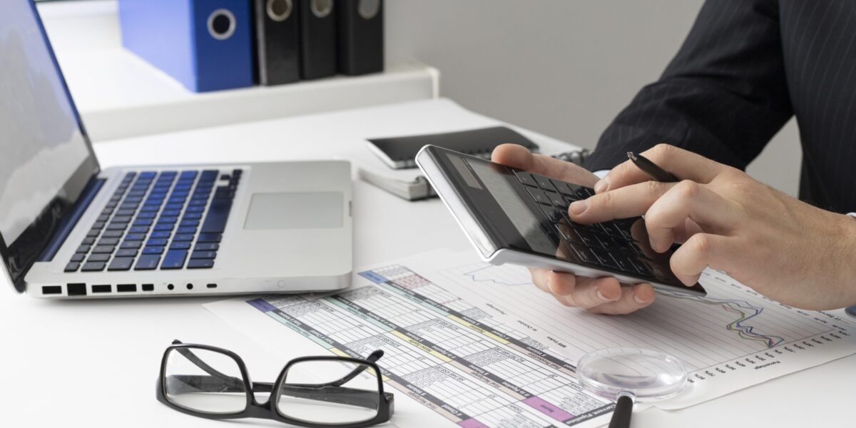side-view-business-man-calculating-finance-numbers