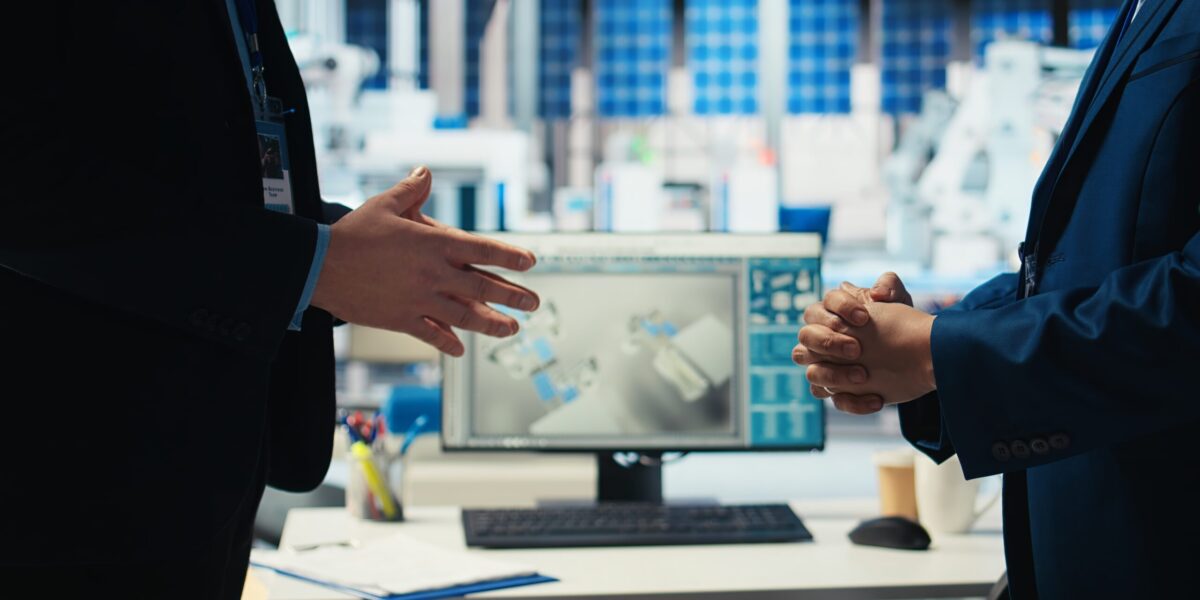 Photovoltaics factory manager and investor shaking hands, reaching agreement for producing sustainable green energy. Businessmen in solar panels facility finalize partnership with handshake