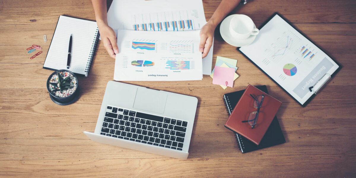 Top view of young  Businessman woman hands reviewing analyzing financial data chart.